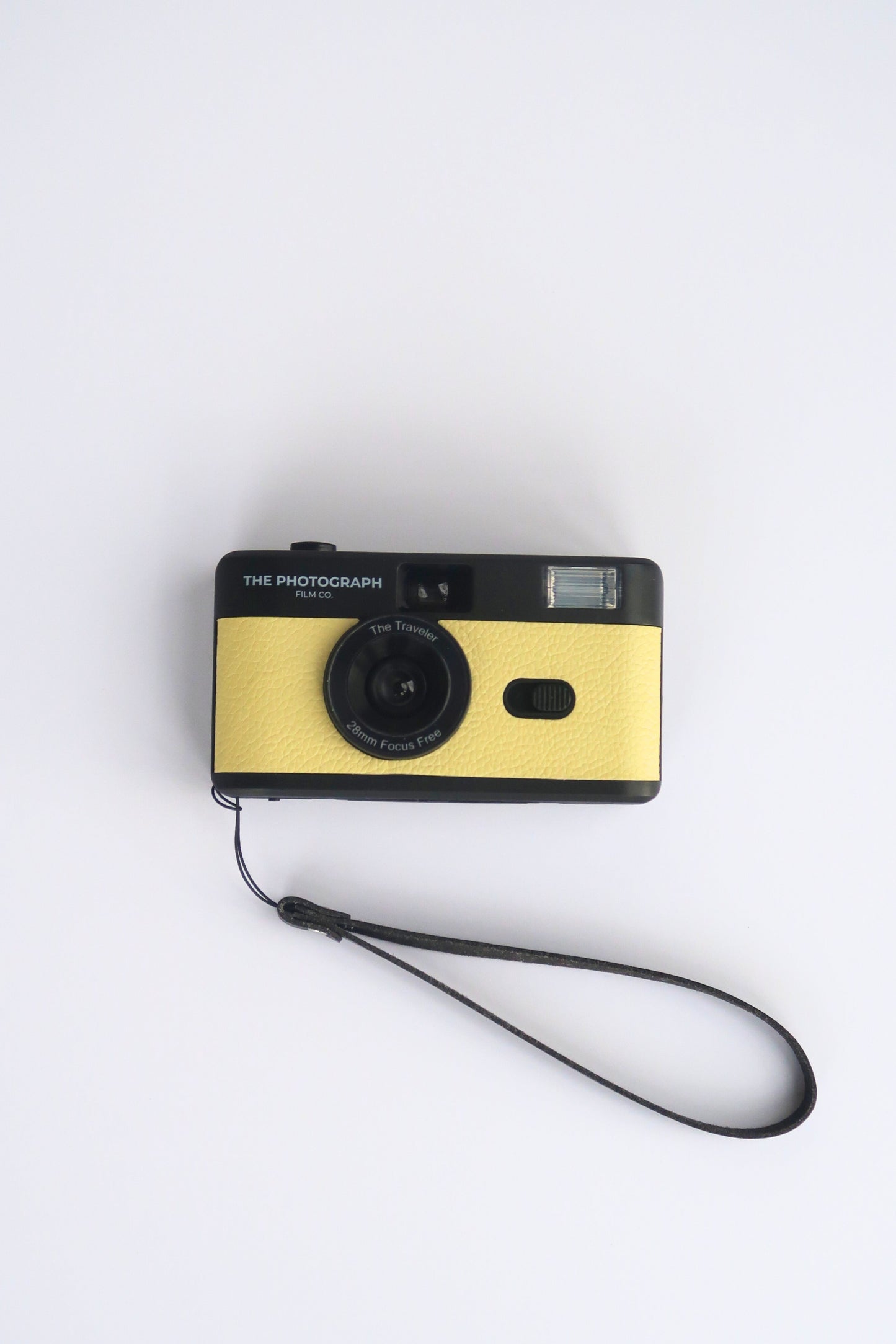 The Traveler Yellow Reusable Film Camera on a travel adventure, compact and eco-friendly 35mm film camera.