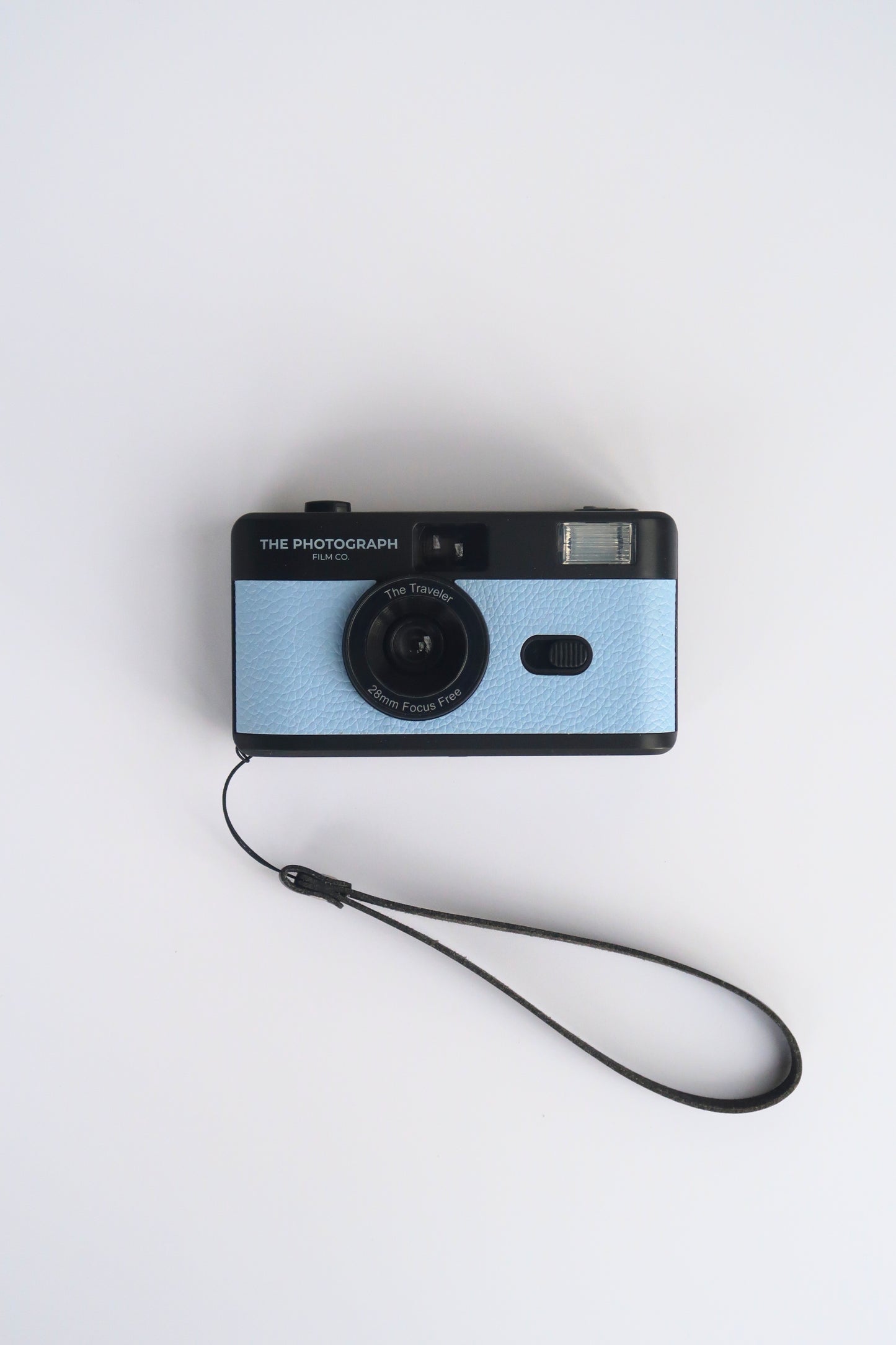 The Traveler Powder Blue Reusable Film Camera on a travel adventure, compact and eco-friendly 35mm film camera.