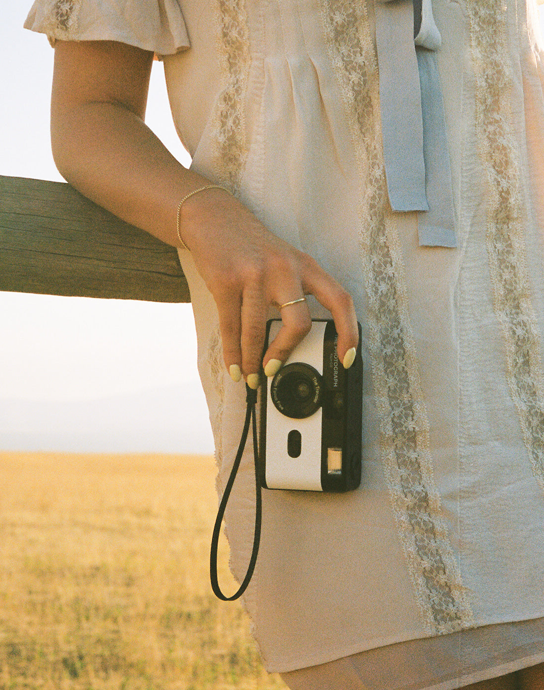 Person holding The Traveler white 35mm reusable film camera