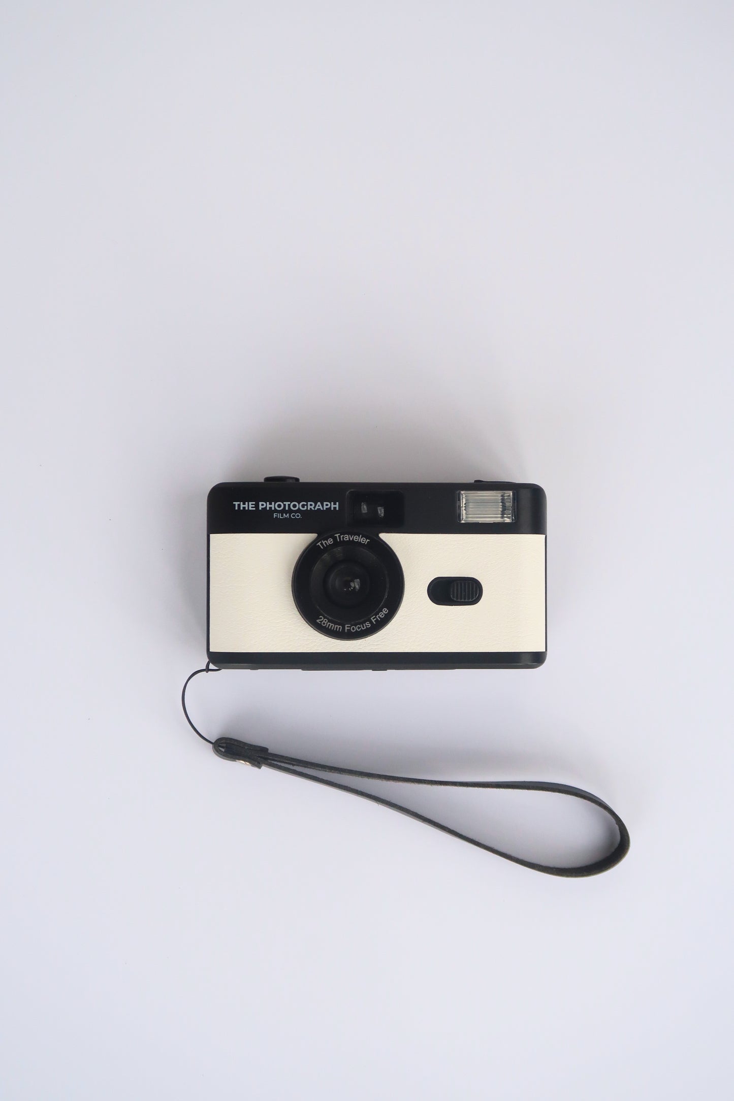 The Traveler White Reusable Film Camera on a travel adventure, compact and eco-friendly 35mm film camera.